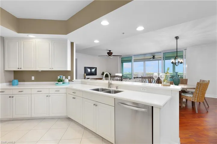 Kitchen featuring dishwasher, a sink, a ceiling fan, a peninsula, and recessed lighting