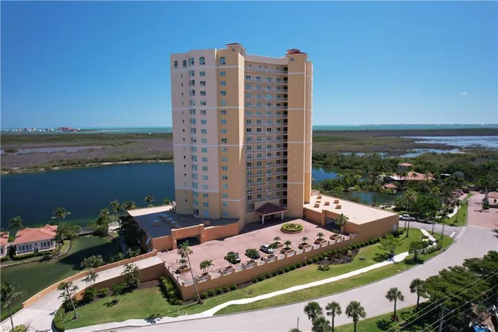 Drone / aerial view of apartment complex / building and a nearby body of water