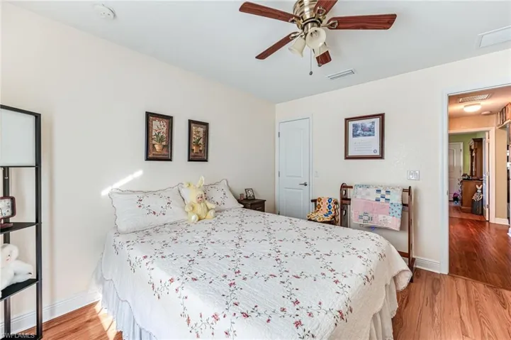 Bedroom with hardwood / wood-style floors and ceiling fan