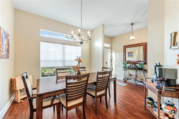 Dining room featuring dark hardwood / wood-style flooring and an inviting chandelier