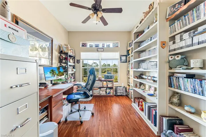 Office with wood-type flooring and ceiling fan