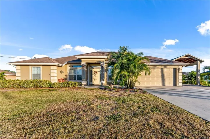 Single story home featuring a front yard and a garage
