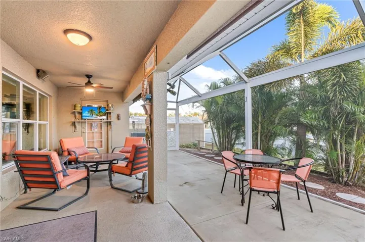 View of patio / terrace featuring a storage shed, ceiling fan, and a lanai