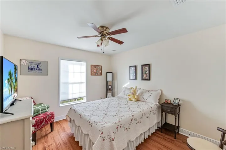 Bedroom with ceiling fan and light wood-type flooring