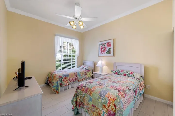 Bedroom featuring ornamental molding and ceiling fan