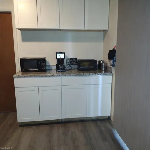 Kitchen featuring white cabinets