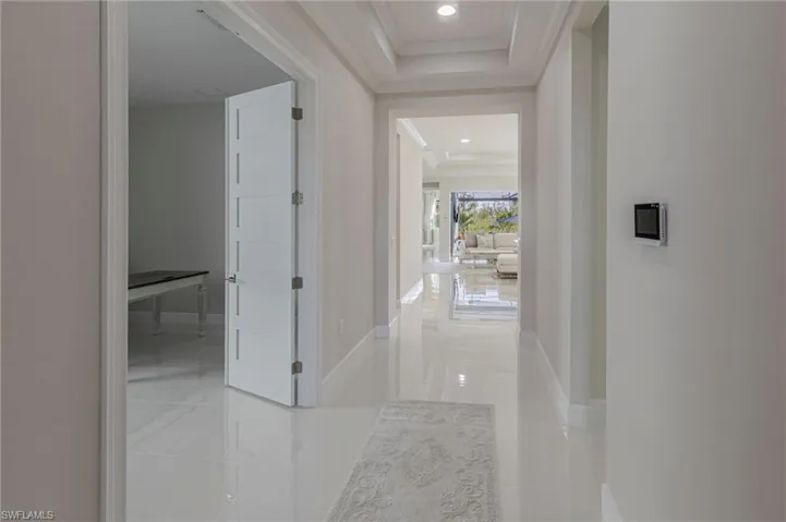 Hall featuring crown molding and tile patterned flooring