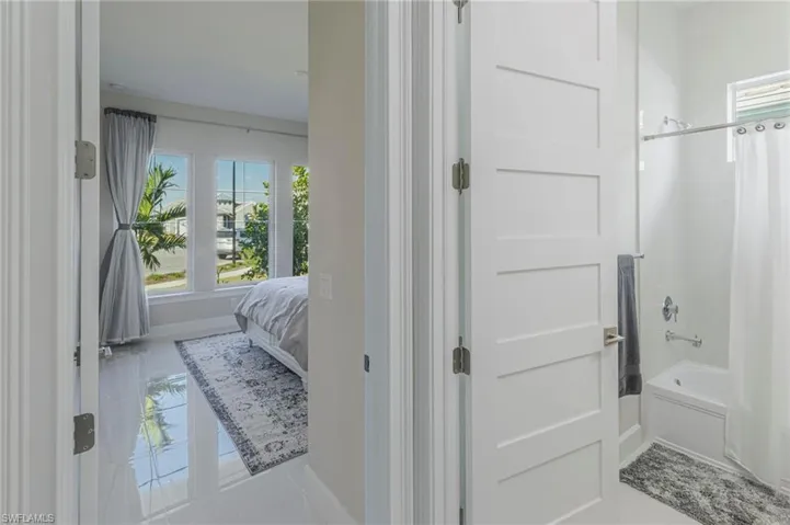 Bathroom with tile patterned floors and shower / bathtub combination with curtain