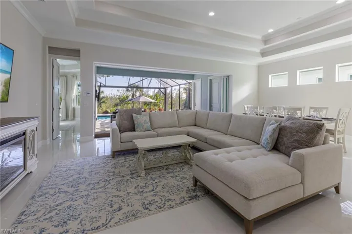 Living room featuring plenty of natural light, ornamental molding, and light tile patterned floors