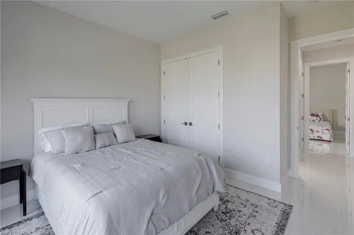 Tiled bedroom with a closet