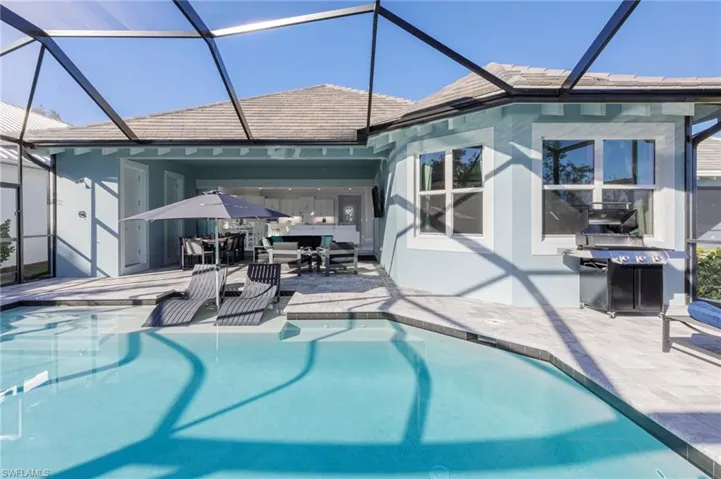 View of pool with a lanai and a patio area