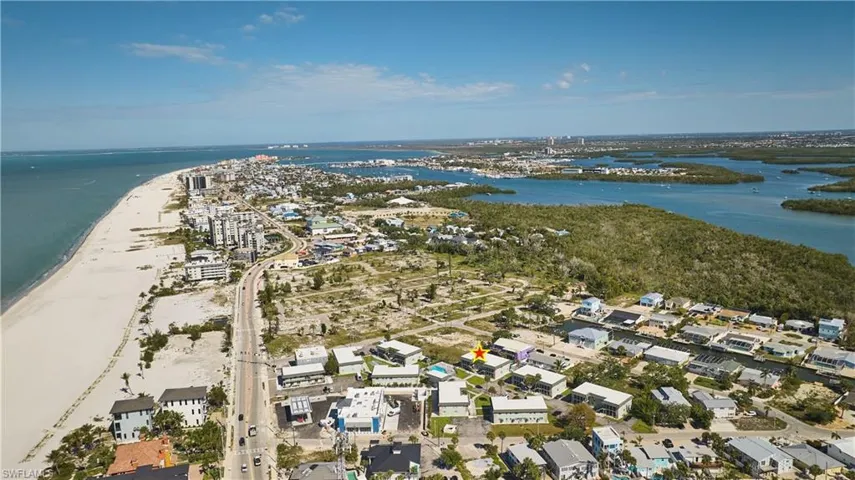 Coastal aerial showcasing beachfront properties alongside a major thoroughfare