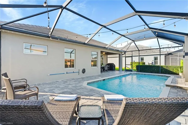 View of pool with a patio, a lanai, and area for grilling