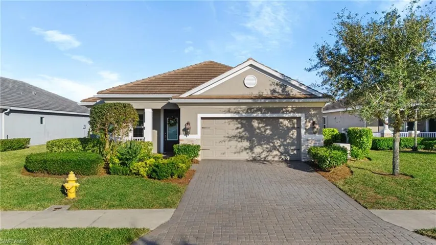 View of front of property featuring a garage and a front yard