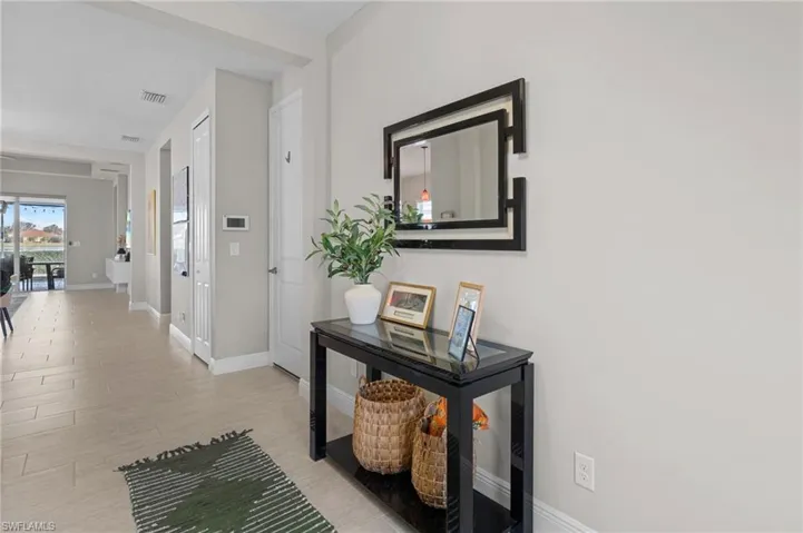 Hallway with light hardwood / wood-style flooring