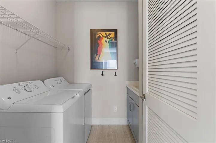 Laundry room featuring cabinets and independent washer and dryer