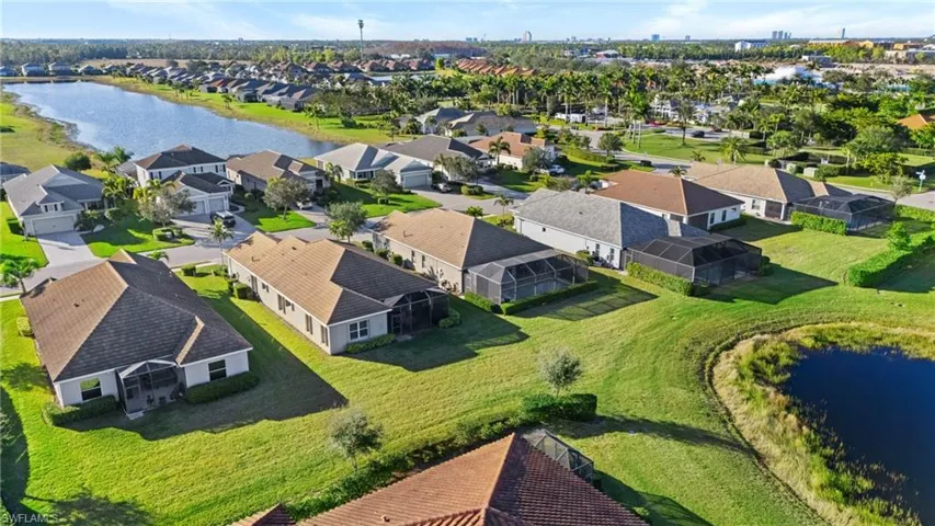 Birds eye view of property with a water view