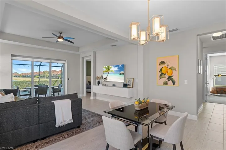 Dining room with a tray ceiling and ceiling fan