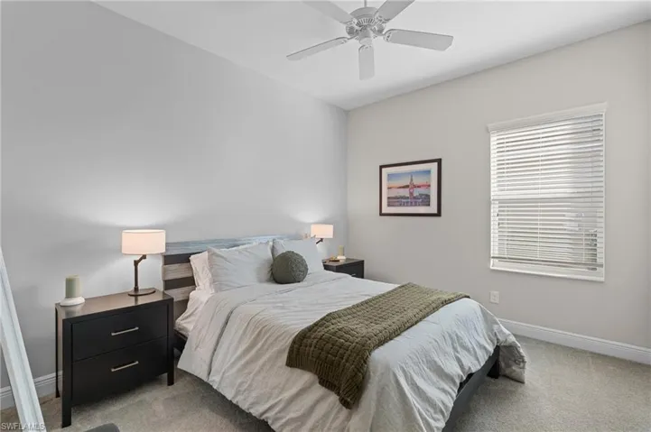 Bedroom with light carpet and ceiling fan
