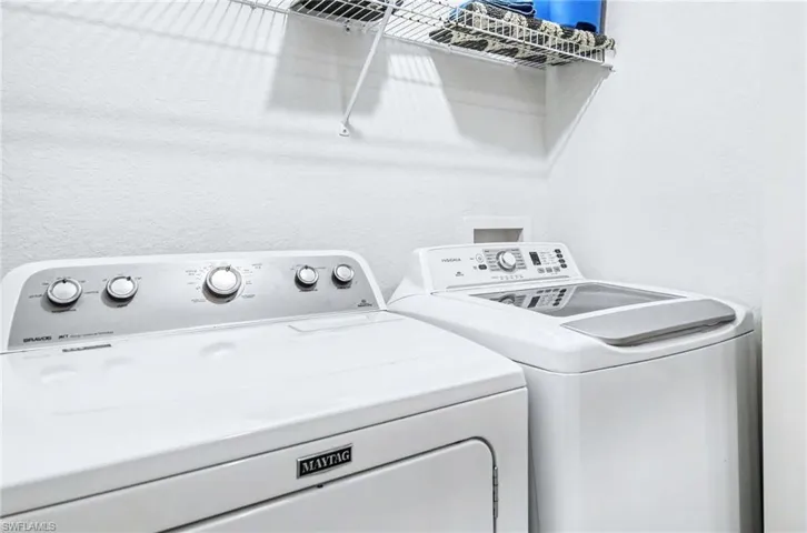 In-unit laundry with convenient shelving.