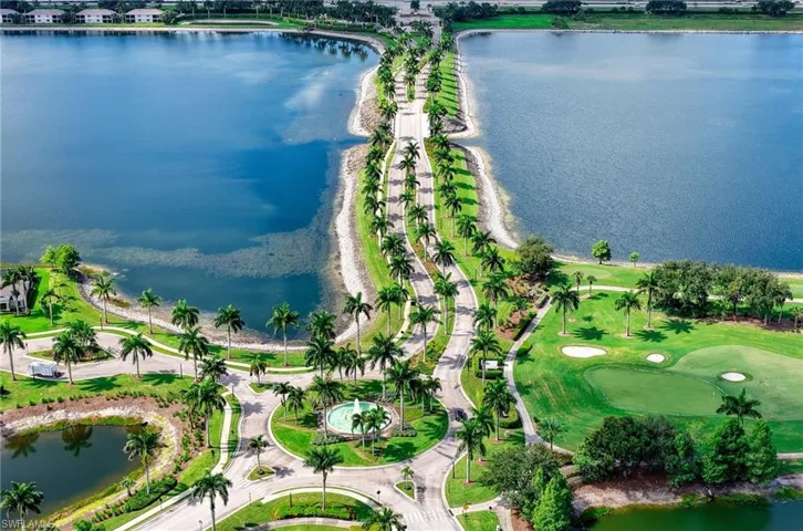 Elegant entryway surrounded by expansive lakes, lush landscaping and swaying palm trees creating a true Southwest Florida welcome.