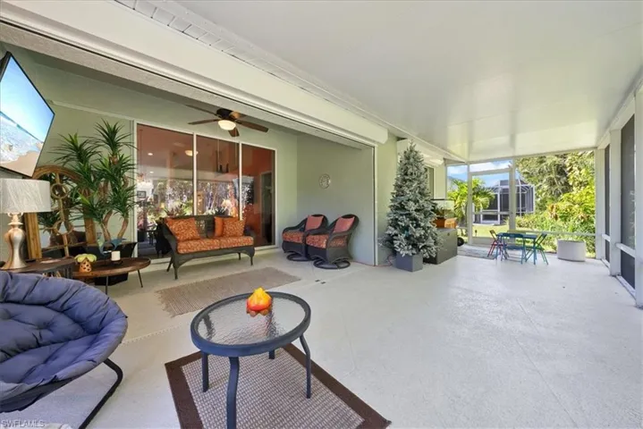 Sunroom / solarium with an outdoor living space and a ceiling fan