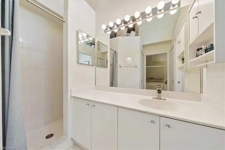 Bathroom with a tile shower and vanity