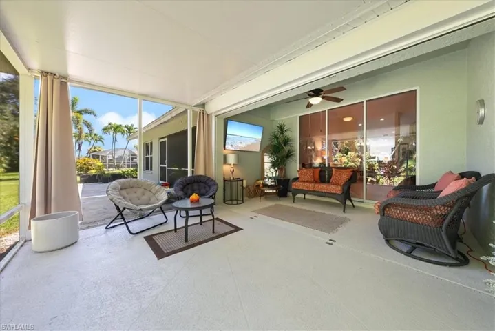 Sunroom with plenty of natural light, ceiling fan, and an outdoor hangout area