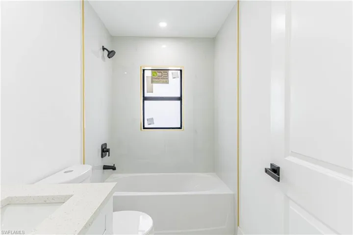 Bathroom featuring vanity and  shower combination