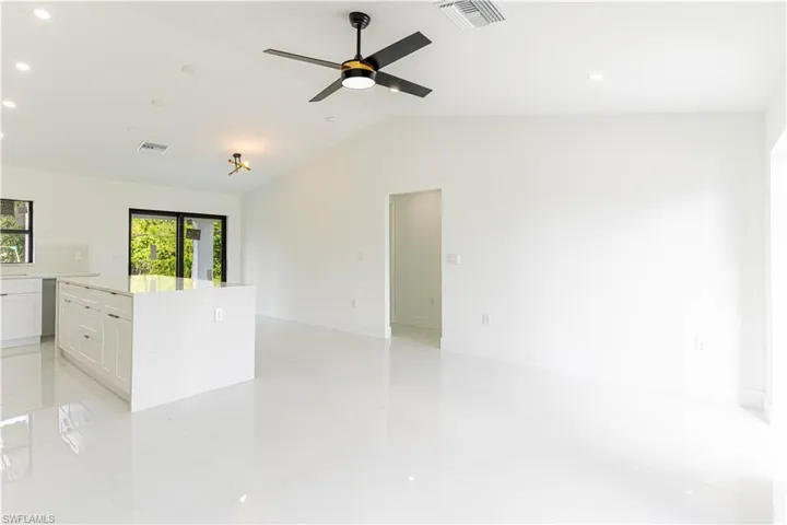 Empty room featuring lofted ceiling, recessed lighting, and ceiling fan
