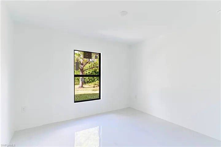 Spare room with baseboards and concrete flooring