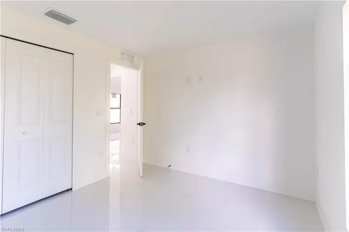 Unfurnished bedroom featuring a closet and finished concrete floors