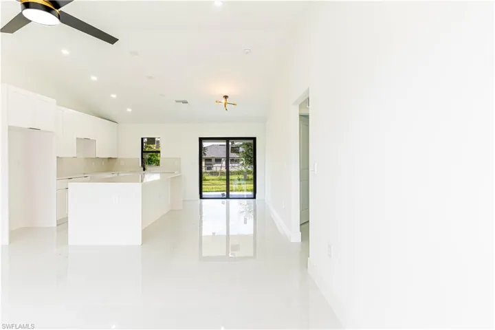 Spare room with recessed lighting, lofted ceiling, light tile patterned flooring, and ceiling fan