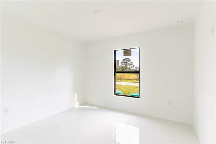 Unfurnished room with baseboards and concrete floors