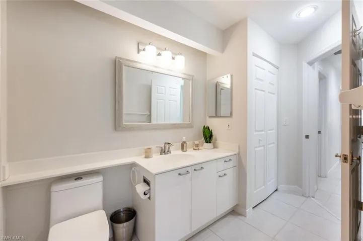 Bathroom featuring vanity, toilet, and tile patterned flooring