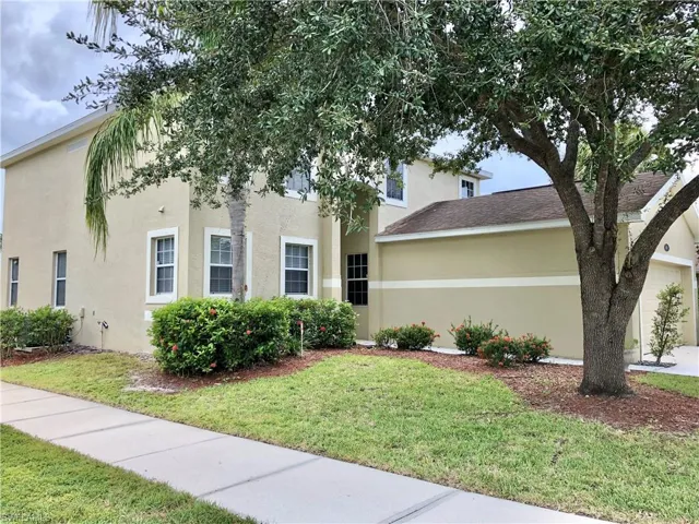 View of front of house with a front lawn and stucco siding