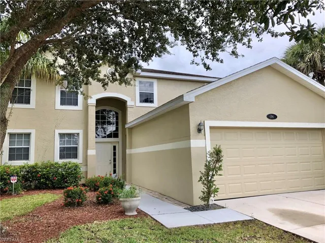 View of front facade featuring stucco siding, an attached garage, and concrete driveway