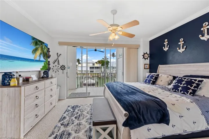 Carpeted bedroom with access to exterior, ceiling fan, and crown molding