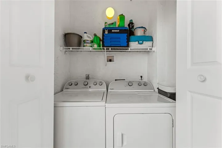 Washroom featuring washer and clothes dryer