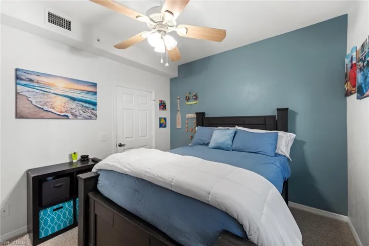 Carpeted bedroom with ceiling fan