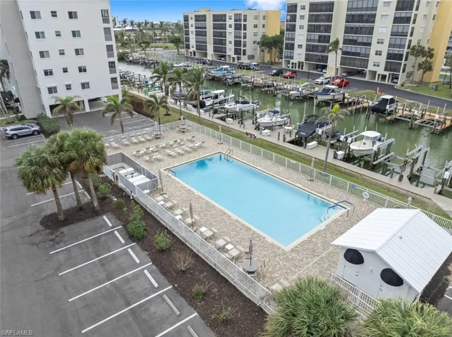 View of swimming pool featuring a water view and a patio area