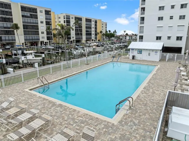 View of swimming pool featuring a patio and a water view