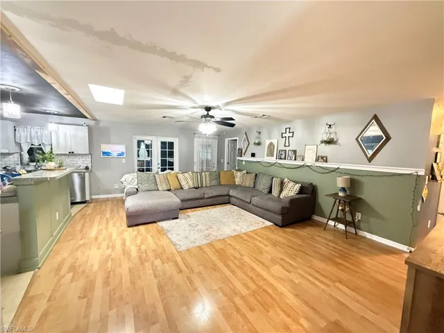 Living room featuring light wood-style flooring and ceiling fan