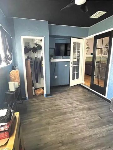 Bedroom with a closet, wood-type flooring, and a ceiling fan