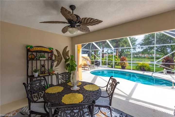 View of swimming pool with ceiling fan