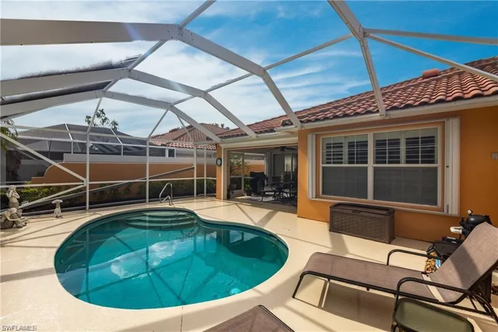 View of swimming pool featuring a lanai and a patio