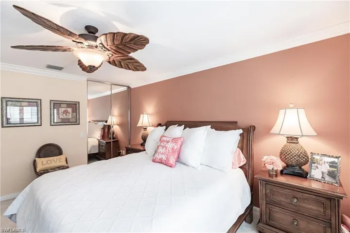 Bedroom with ornamental molding, a closet, and ceiling fan