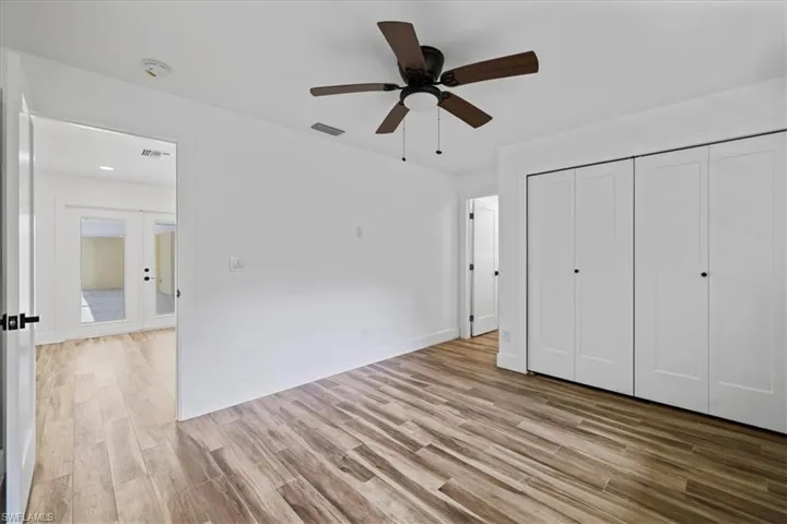 Unfurnished bedroom#2 with light wood-type flooring, a closet, ceiling fan, and french doors