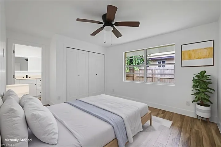 Bedroom virtualy staged with wood finished floors, a closet, a ceiling fan, and ensuite bath