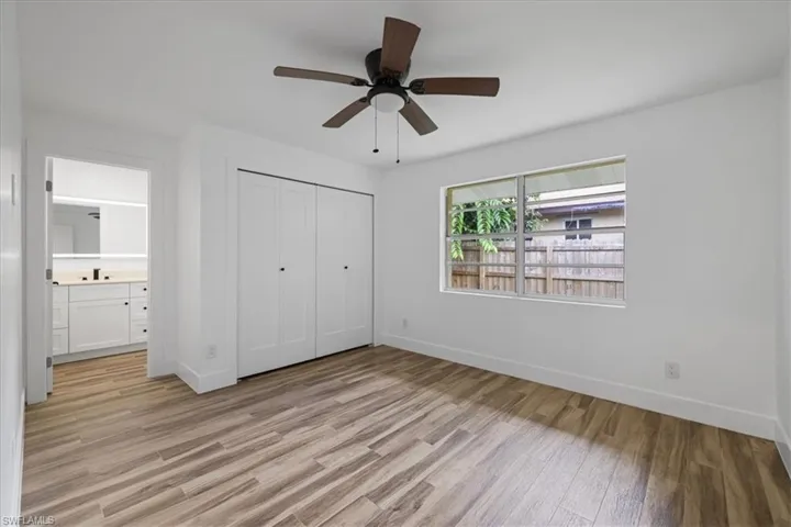 Guest bedroom#2 with light wood-type flooring, a closet, ceiling fan, and ensuite bathroom